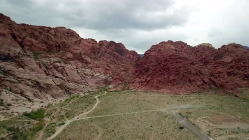 Wide Aerial shot flying toward red rock outcropping at Red Rock Canyon Nevada