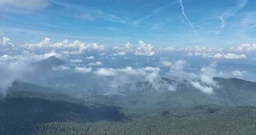 Aerial View of Cloud Shrouded Forest Mountains