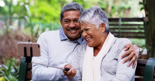4k video footage of a mature couple taking selfies at the park