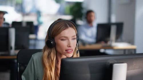 Woman Providing Customer Service Talking in Headset at Coworking Space Closeup