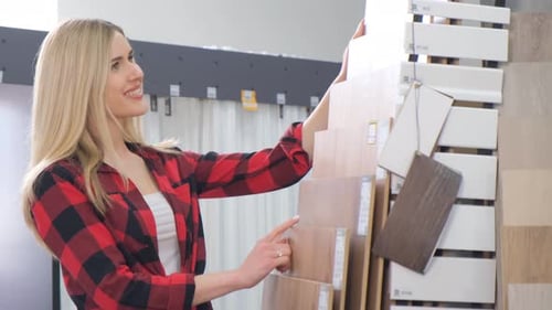 Woman Smiles While Picking Wood Flooring Samples