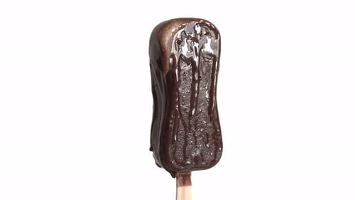chocolate flowing liquid chocolate. Ice cream melts on a wooden stick