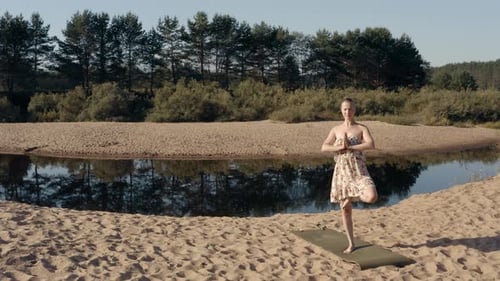 Girl Is Doing Morning Yoga On The River 2