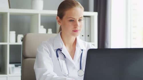 Doctor Works in the Medical Office Woman in White Coat Workplace of a Professional Female Therapist