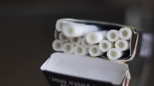 A Hand Takes a Cigarette From an Open Pack on the Table Nicotine Addiction a Bad Habit Heart Disease