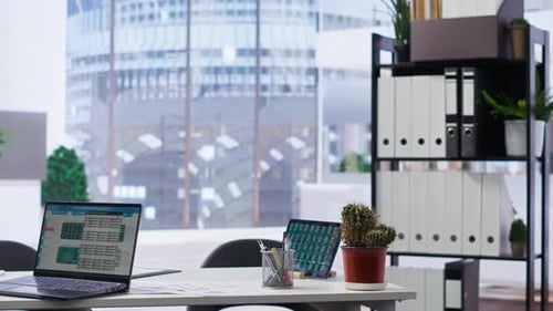 Empty Company Financial Department with Stock Portfolio on Laptops