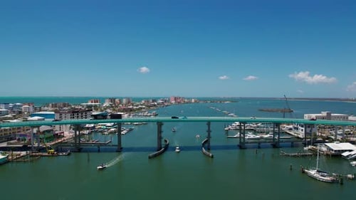 Drone shot of traffic moving over the Fort Myers Bridge on a sunny day