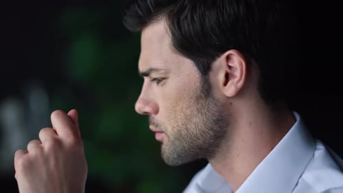 Contemplative man in profile thinking in office