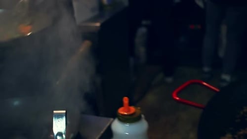 Chef prepares fresh Thailand food stir fry in a hot steaming wok pan