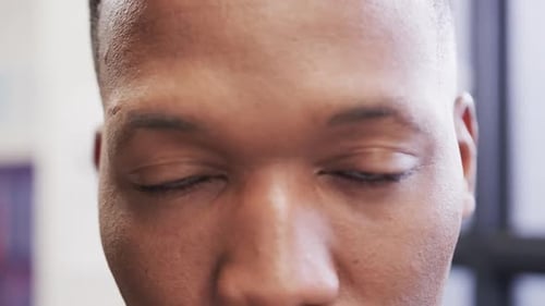 Close up portrait of happy african american male creative at casual office, in slow motion