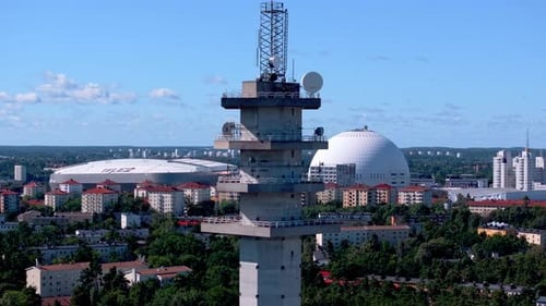 Aerial View of a Concrete Telecommunications Tower Overlooking the Dense Urban Landscape of