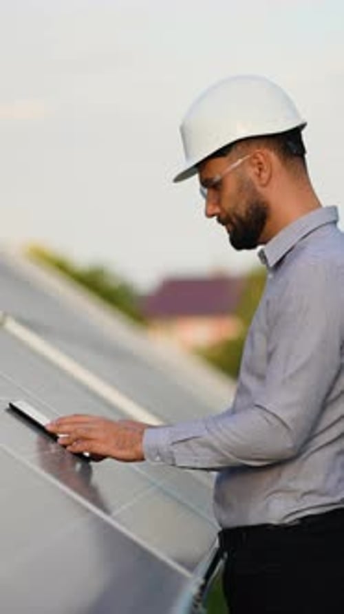 Engineer Performing Solar Panel Maintenance with Tablet