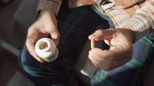 Macro View Man Takes Pill Drinks Water From Glass