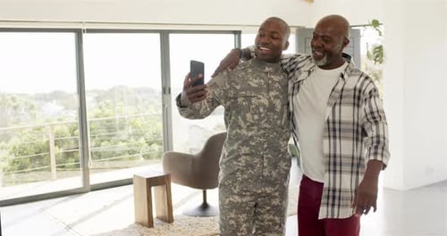 Soldier and Father Taking Selfie Together Indoors