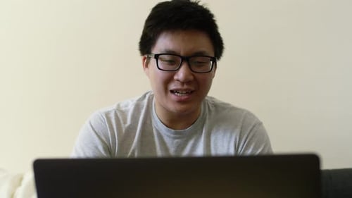 Man Talking in Front of Laptop Indoors