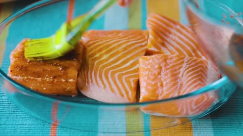 Raw Salmon Pieces Brushed with Marinade in Dish