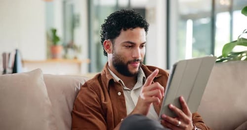 Typing, chat and tablet with man on sofa for social media post, reading and online update