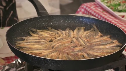 Small Fried Fish Cooking on Gas Range