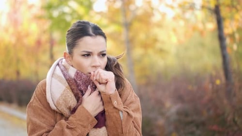 Woman Coughing, Outside in Autumn Park