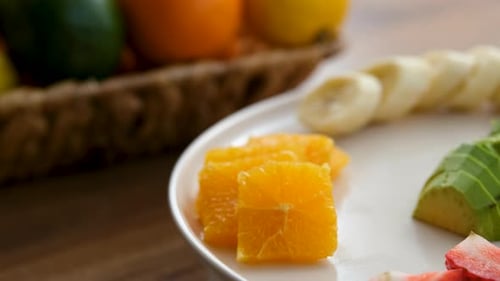 Close Up View Of Fruit Plate Rotating Clockwise Next To Fruit Basket