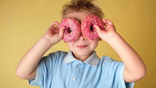 Happy Child Holding Glazed Donut