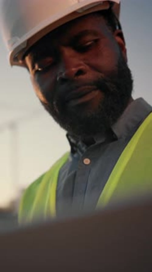 Portrait of Professional Contractor or Architect Looking at Computer Display in Construction Site