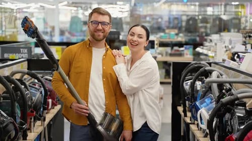 Happy Couple with New Vacuum Cleaner in Tech Store
