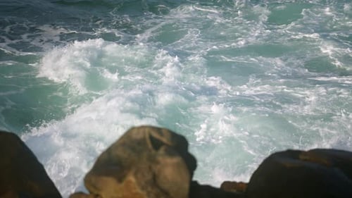 Turquoise Waves Crash on Rugged Shore Clifftop View Over Dynamic Ocean Rocks Endure Ceaseless Surge