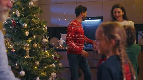 Family together Christmas gifts and dancing at home