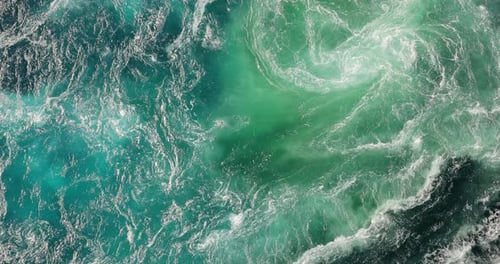 Blue waves of water of the river and the sea meet each other during high tide and low tide.