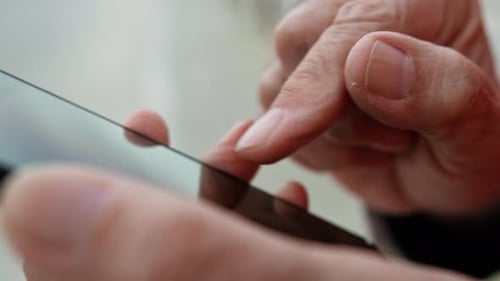 Senior Hands Using Smartphone Close Up