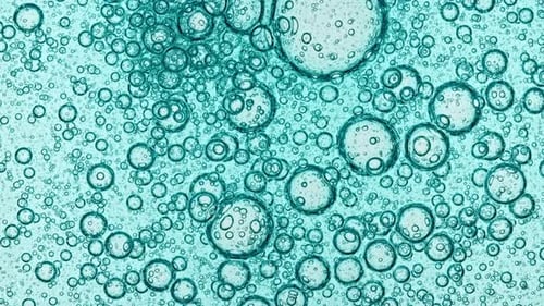 Transparent Cosmetic Blue Gel Fluid with Molecule Bubbles Oil Spreading on a White Background Macro