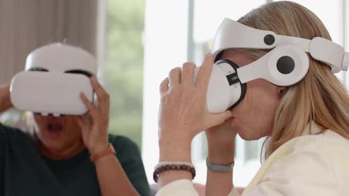 Mature Women Enjoying Virtual Reality Experience With Headsets