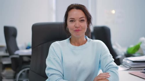 A Confident Woman in a Professional Office Setting Reflecting Strength and Ambition