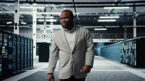 Smiling Employee Walking in High Tech Data Center