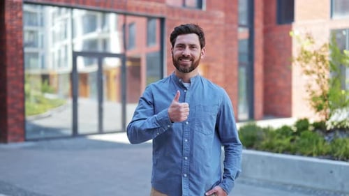 Successful Businessman Gives Thumbs Up Near Office Building