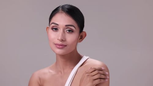 Glamorous Woman Posing Elegantly in a Studio Setting