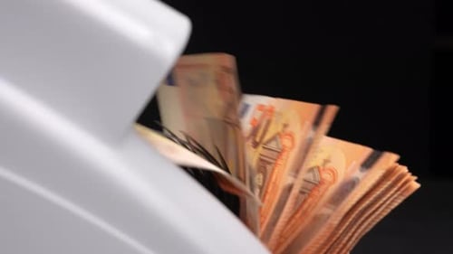 Money Counter Counting Euro Currency in Studio Setting