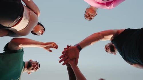 Diverse Team Joining Hands in Circle