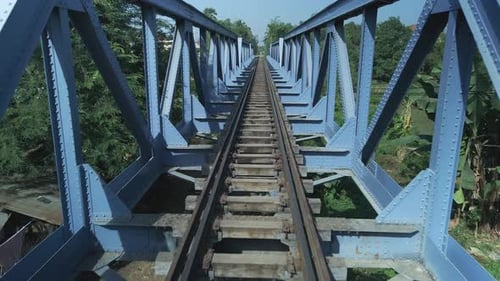 Railway bridge, symmetrical structure drone fly through, track view.