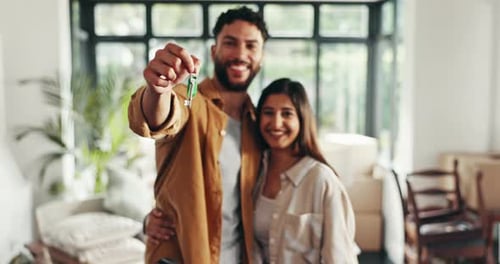 Smiling Couple Holding Keys to New Home