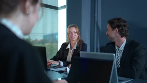 Cheerful Business Colleagues Meeting at Conference Table