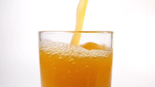 Freshly Juiced Juice is Poured Into a Glass