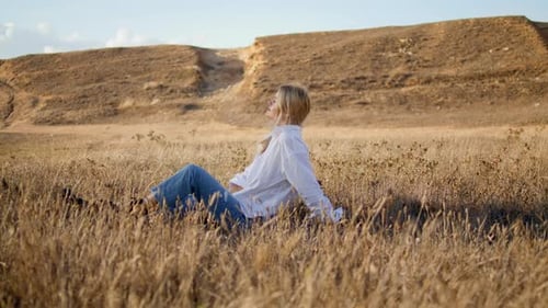 Contemplative Girl Sitting Field Alone