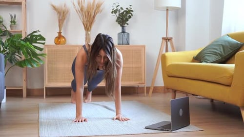 Woman Exercising and Doing Yoga on Mat Indoors