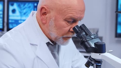 Senior Man Looking in Microscope in Research Lab