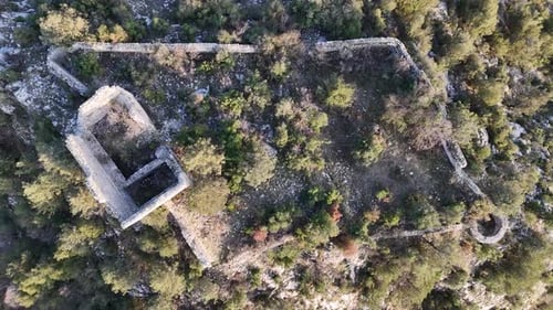 Drone view of the flag on top of the castle ruins among the trees on the mountain top, Belenkeşlik C