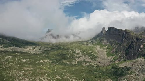 A Majestic Panorama of Towering Mountain Peaks Surrounded By Billowing Clouds