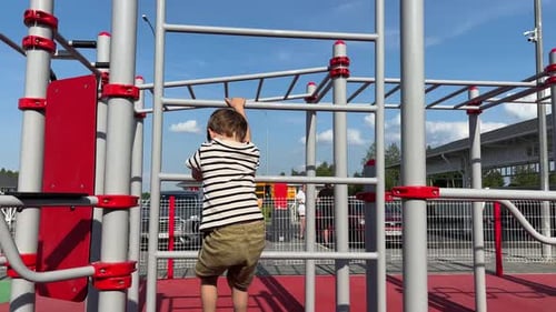Strong and Brave Child Boy is Engaged in Rock Climbing on a Street Climbing Wall Toddler Leisure