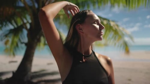 Woman Relaxing Under Palm Tree on Tropical Beach
